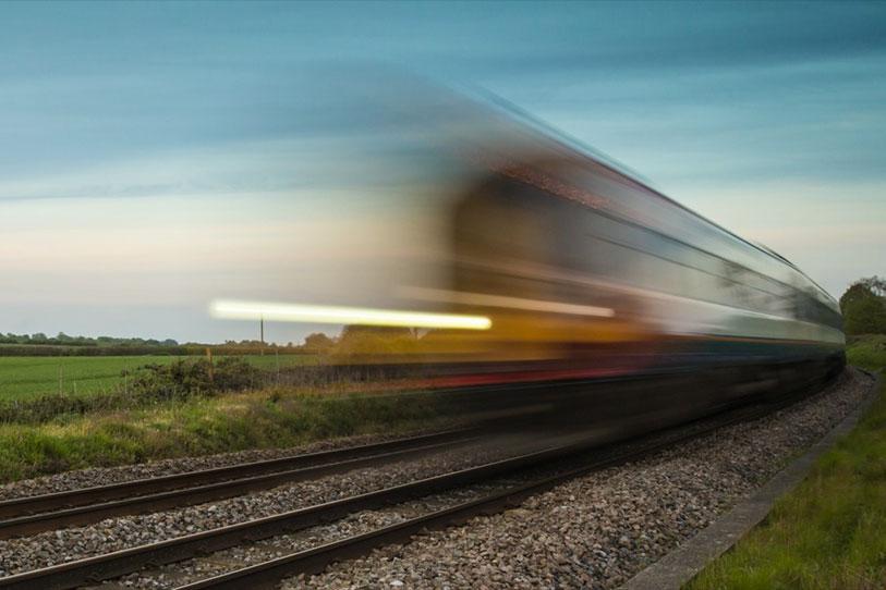 Train shown blurred to indicate the high speed of travel
