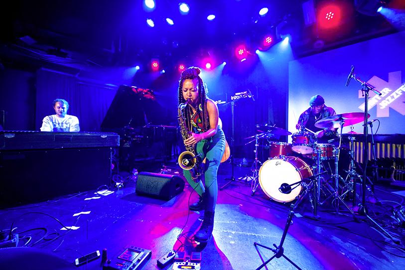 Female musician playing a saxophone onstage